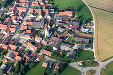 Oblique view of Village - view on the edge of agricultural fields and farmland in Moenchsdeggingen in the state Bavaria, Germany