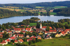 Village view on Illmensee from the northeast with Catholic Church of the Assumption in Illmensee in the state Baden-Wuerttemberg, Germany