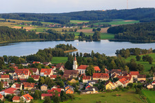 Aerial view of Village view on Illmensee from the northeast with Catholic Church of the Assumption in Illmensee in the state Baden-Wuerttemberg, Germany