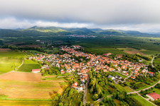 Village - view on the edge of agricultural fields and farmland in morning light below low clouds in Goecklingen in the state Rhineland-Palatinate, Germany