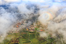 View of the town under clouds from the east with the Catholic parish church of St. Stephan in Albersweiler in the state Rhineland-Palatinate, Germany