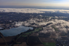 Gravel pit for gravel extraction by Pfadt GmbH Kieswerk-Baustoffe under clouds in Leimersheim in the state Rhineland-Palatinate, Germany