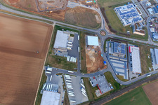 Oblique view of Industrial area in Speyer Valley with TRANSAC International Speditionsgesellschaft mbH, Markthalle 5, and the construction site of the new Kardex Software GmbH building in Rülzheim in the state Rhineland-Palatinate, Germany