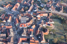 Protestantic Church building in the center of a circle of houses in the village of in Dossenheim-sur-Zinsel in Grand Est, France from the plane
