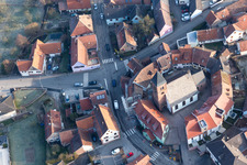 Protestantic Church building in the center of a circle of houses in the village of in Dossenheim-sur-Zinsel in Grand Est, France viewn from the air