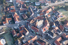 Drone recording of Protestantic Church building in the center of a circle of houses in the village of in Dossenheim-sur-Zinsel in Grand Est, France