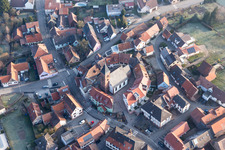 Drone image of Protestantic Church building in the center of a circle of houses in the village of in Dossenheim-sur-Zinsel in Grand Est, France