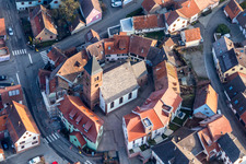 Church building of St. Leonhard surrounded by a circle of houses in the village of in Dossenheim-sur-Zinsel in Grand Est, France