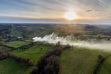Smoke clouds of a fire in a cornfield in Saisy in Bourgogne-Franche-Comte, France