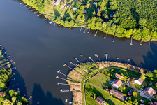 Forest areas on the shores of Lake Ètang de Hirbach with fishing piers in Holving in the state Moselle, France