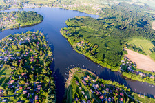 Aerial view of Forest areas on the shores of Lake Ètang de Hirbach with fishing piers in Holving in the state Moselle, France