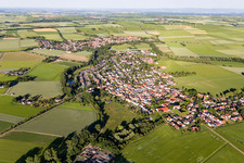 Agricultural land and field borders surround the settlement area of the village in Hahnheim in the state Rhineland-Palatinate, Germany
