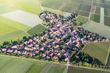 Agricultural land and field borders surround the settlement area of the village in Frettenheim in the state Rhineland-Palatinate, Germany