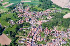 Aerial view of Village - view on the edge of agricultural fields and farmland in Gumbrechtshoffen in Grand Est, France
