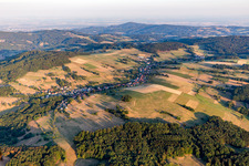 Agricultural land and field borders surround the settlement area of the village in Gumpen in the state Hesse, Germany