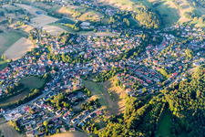 Agricultural land and field borders surround the settlement area of the village in Kirschhausen in the state Hesse, Germany from above