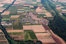 Aerial view of Agricultural land and field borders surround the settlement area of the village in Freisbach in the state Rhineland-Palatinate, Germany