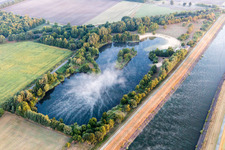Aerial view of Inselsee in the morning mist on the Elbe Lateral Canal at Scharnebeck in Scharnebeck in the state Lower Saxony, Germany
