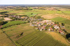 Agricultural land and field borders surround the settlement area of the village in Lanze in the state Schleswig-Holstein, Germany