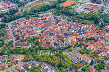 Old town center with the Catholic Church of St. Peter and Paul at the cemetery in Grünsfeld in the state Baden-Wuerttemberg, Germany