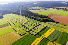 Wind turbine windmills on a solar panel field in Alpirsbach in the state Baden-Wurttemberg, Germany