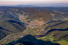 Aerial view of Location view of the streets and houses of residential areas in the valley landscape surrounded by mountains of the black forest in Haslach im Kinzigtal in the state Baden-Wurttemberg, Germany
