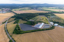 Panel rows of photovoltaic and solar farm or solar power plant on an old landfill of Kommunaler Abfallservice of Landkreises Gotha in Leinatal in the state Thuringia, Germany