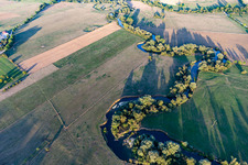 Curved loop of the riparian zones with willows on the course of the river Maas/Meuse in Maxey-sur-Meuse in Grand Est, France