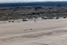 Aerial view of Buggies and kite surfers on the sandy beach in Fanø in the state South Denmark, Denmark