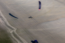 Oblique view of Buggies and kite surfers on the sandy beach in Fanø in the state South Denmark, Denmark