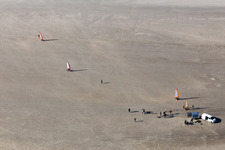 Buggies and kite surfers on the sandy beach in Fanø in the state South Denmark, Denmark seen from above
