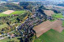 Aerial view of Agricultural land and field borders surround the settlement area of the village in Zizenhausen in the state Baden-Wurttemberg, Germany