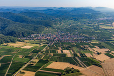 Agricultural land and field borders surround the settlement area of the village in Oberotterbach in the state Rhineland-Palatinate, Germany from above