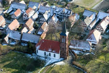 Wintry snowy protestantic Church building in the village of in Hunspach in Grand Est, France