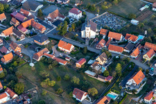 Grave rows on the grounds of the cemetery on catholic church in Schoenenbourg in Grand Est, France