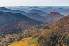 Autumnal discolored vegetation view of castle of the fortresses Trifels, Scharfeneck and Anebos at sunset in Annweiler am Trifels in the state Rhineland-Palatinate, Germany