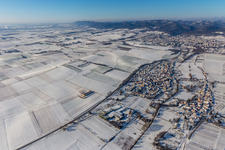 Wintry snowy village - view on the edge of agricultural fields and farmland in Niederhorbach in the state Rhineland-Palatinate, Germany