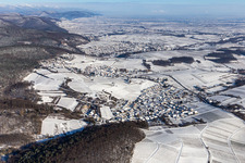Wintry snowy village on the edge of vineyards and wineries in the wine-growing area Suedliche Weinstrasse in Gleishorbach in the state Rhineland-Palatinate, Germany