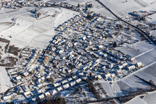 Aerial view of Wintry snowy village on the edge of vineyards and wineries in the wine-growing area Suedliche Weinstrasse in Gleishorbach in the state Rhineland-Palatinate, Germany