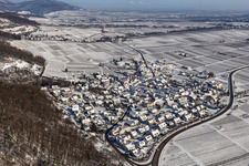 Wintry snowy village - view on the edge of Wine yards below the hilly edge of the Haardt Palatinat forest in Eschbach in the state Rhineland-Palatinate