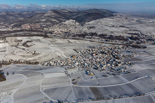 Wintry snowy wine yards surround the settlement area of the village in Birkweiler in the state Rhineland-Palatinate, Germany
