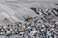 Aerial view of Wintry snowy wine yards surround the settlement area of the village in Birkweiler in the state Rhineland-Palatinate, Germany
