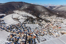 Aerial view of Wintry snowy village on the edge of vineyards and wineries in the wine-growing area Weinstrasse in Burrweiler in the state Rhineland-Palatinate, Germany