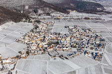 Wintry snowy village on the edge of vineyards and wineries in the wine-growing area in Weyher in der Pfalz in the state Rhineland-Palatinate, Germany