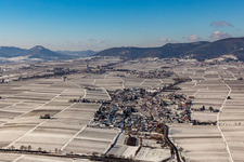 Aerial view of Wintry snowy village - view on the edge of agricultural fields and farmland in Roschbach in the state Rhineland-Palatinate, Germany