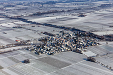 Aerial view of Wintry snowy village - view on the edge of agricultural fields and farmland in Knoeringen in the state Rhineland-Palatinate, Germany