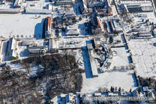 Winter aerial view in the snow of Jugendwerk St. Josef and Caritas Förderzentrum Laurentius und Paulus in the district Queichheim in Landau in der Pfalz in the state Rhineland-Palatinate, Germany