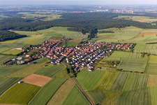 Aerial view of Agricultural land and field boundaries surround the settlement area of the village in Hesselbach in the state Bavaria, Germany