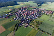Aerial photograpy of Agricultural land and field boundaries surround the settlement area of the village in Hesselbach in the state Bavaria, Germany