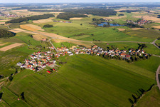 Agricultural land and field boundaries surround the settlement area of the village in Kleinwinnaden in the state Baden-Wuerttemberg, Germany